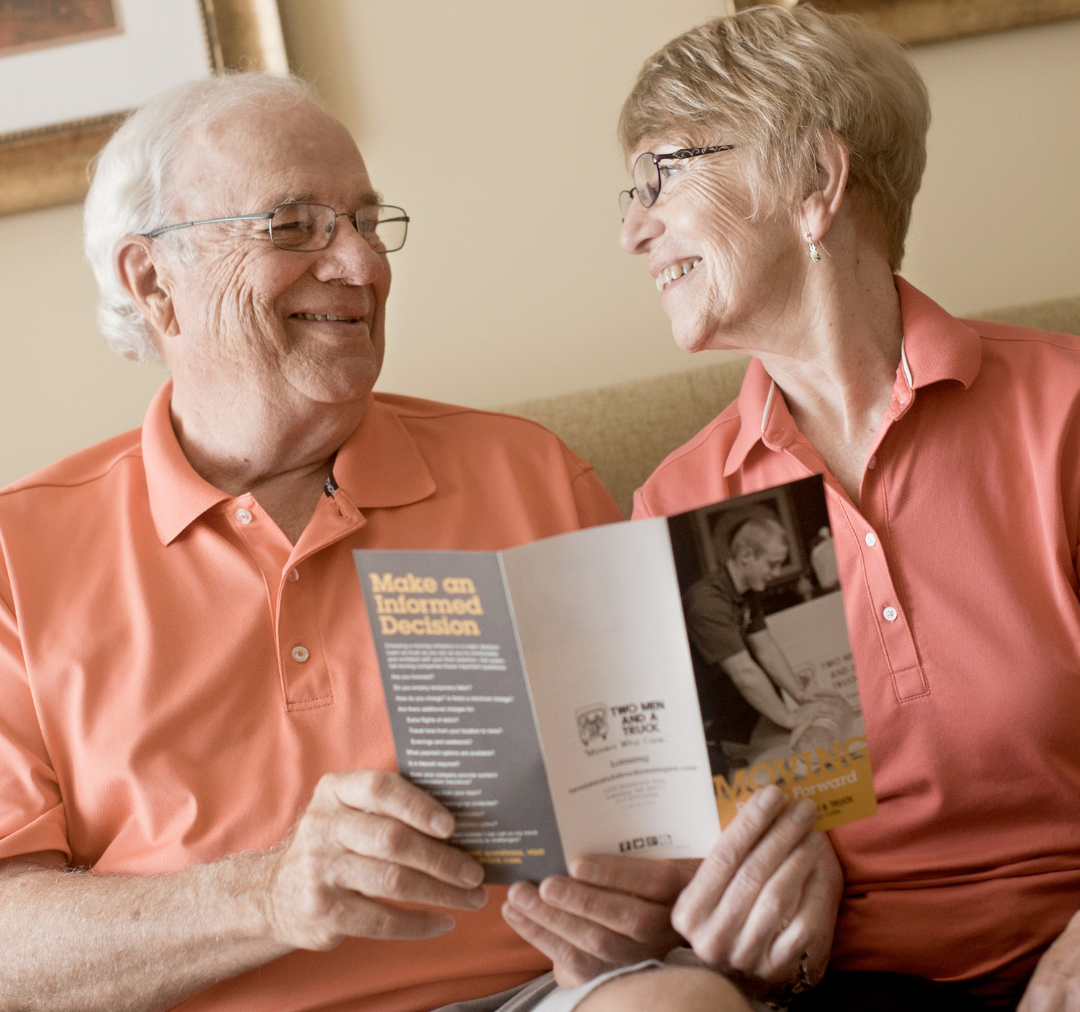 A senior couple reading a moving pamphlet 