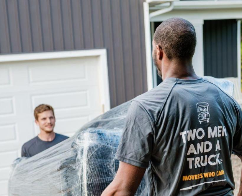 Movers carrying items up ramp