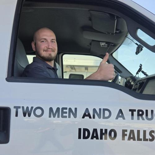 Driver inside a truck, giving a thumbs up