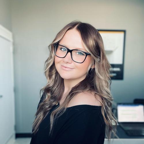 Kayla standing in her office 