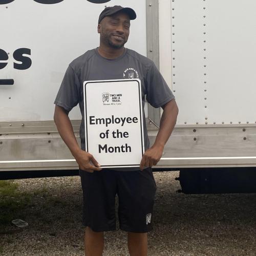 Chad Parker - mover with two men and a truck holding an employee of the month sign