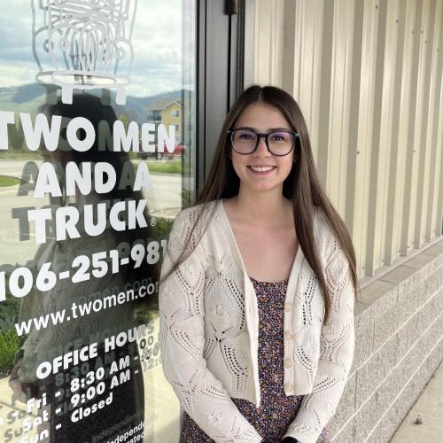 Ciarra in front of two men and a truck door