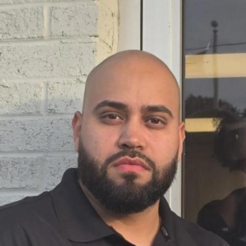 employee pictured in front of office