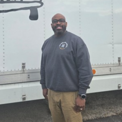 Manager James Dawkins in front of a truck