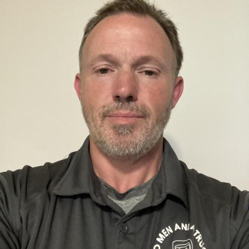 Short Haired Man Wearing a Two Men and a Truck Shirt