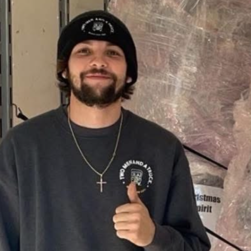 Luke inside a moving truck giving a thumbs up to the camera