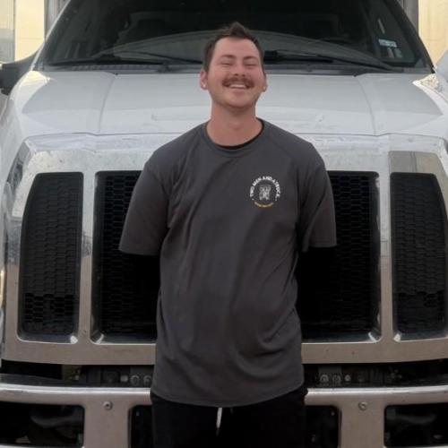 Mover Brayden standing in front of a truck