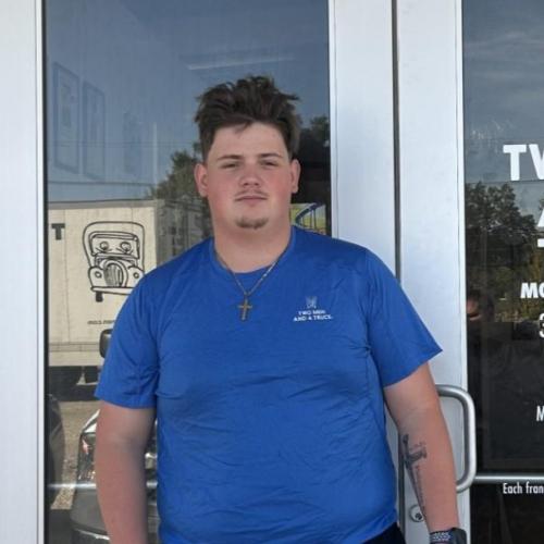 Michael mover of the month with two men and a truck standing in front of our office door