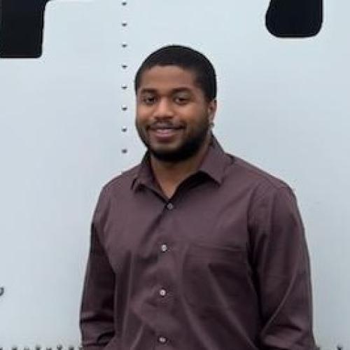 Adrian standing in front of company vehicule
