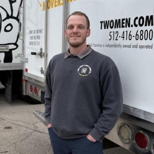Move Manager standing in front of moving trucks in Austin Texas