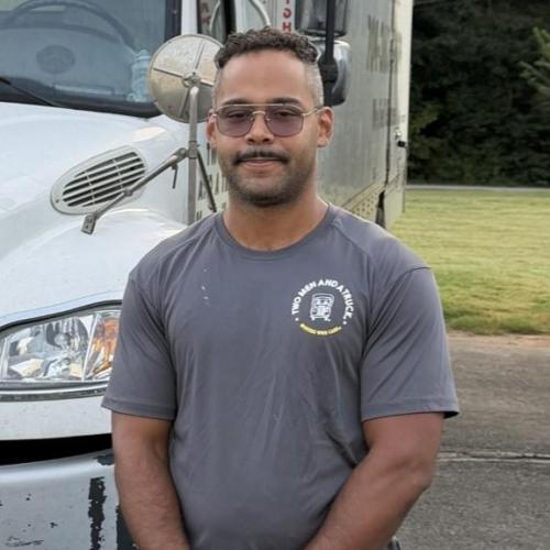 Noah standing in front of a parked moving truck
