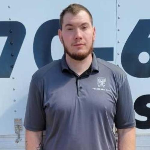 everett is standing in front of a moving truck