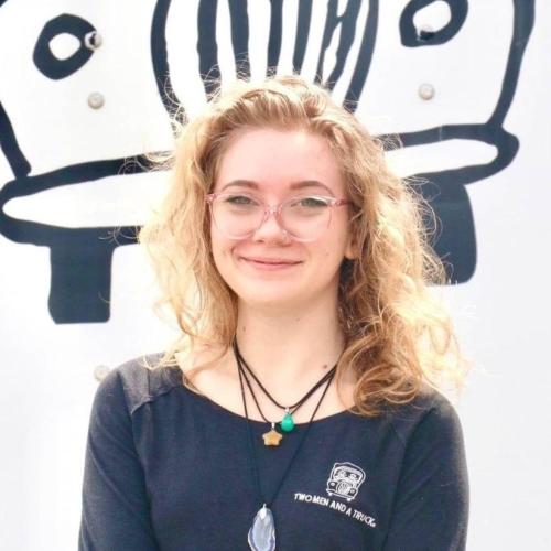 hailey criddle wearing black two men and a truck shirt with truckie logo in the background