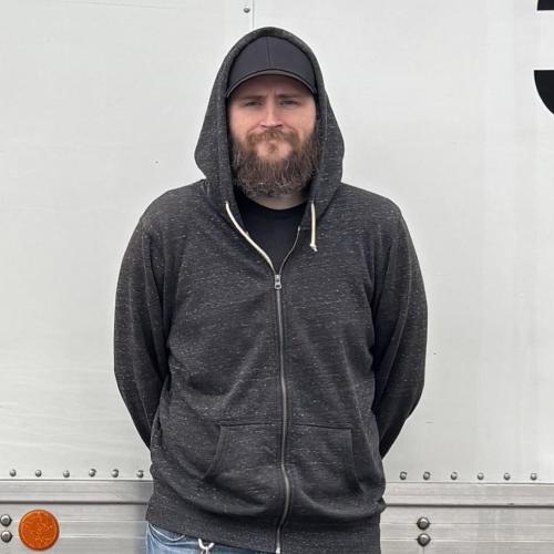 Charles in front of the trucks 