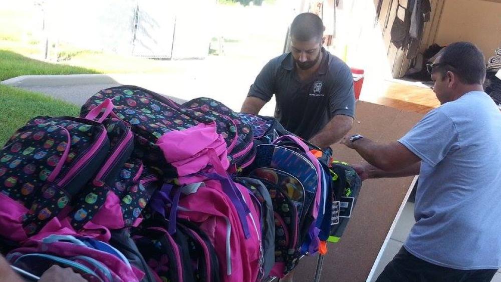 two men and a truck movers moving backpacks