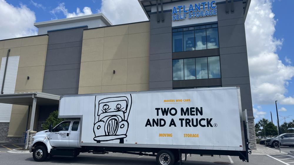 Two Men And A Truck truck in front of Atlantic Self Storage