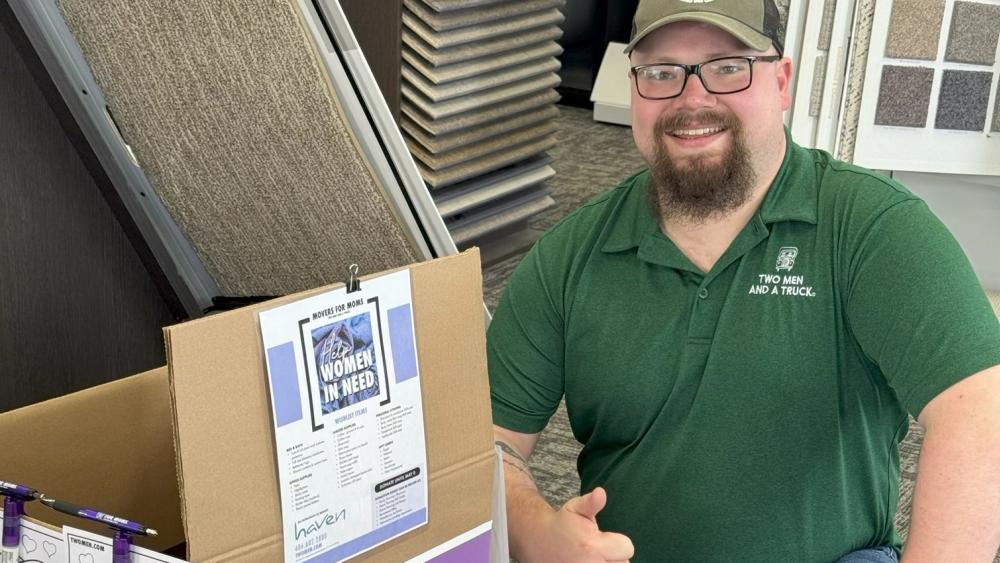 Cole Dropping a Movers for Moms Collection Box at Pierce Carpet Mill Outlet in Bozeman
