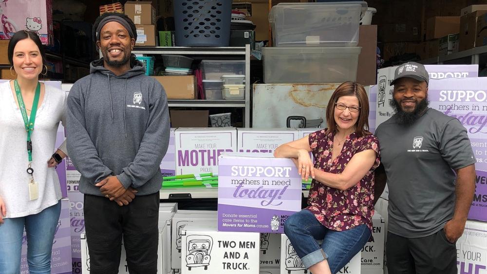 WomenSafe volunteers, Megan and Michele, with Two Men And A Truck's Chris and Dean delivering Movers for Moms items in 2019