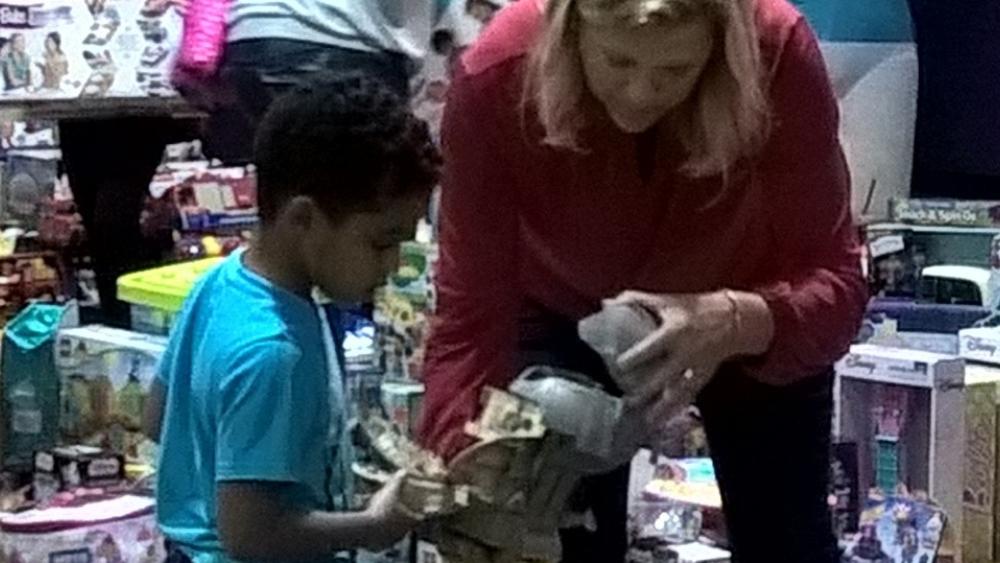 Volunteer showing child a toy