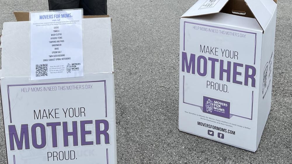 Movers for Moms labeled boxes sitting on pavement