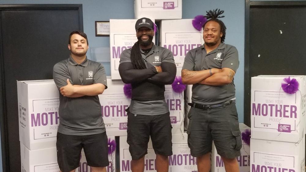TWO MEN AND A TRUCK movers with Movers for Moms donation boxes