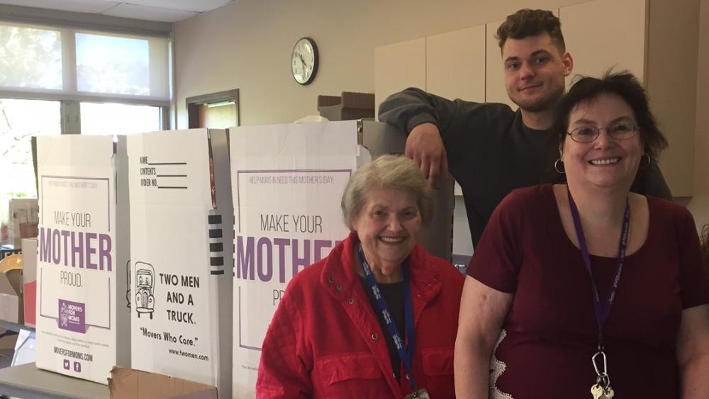 Mover and boxes with staff at Neighborhood House