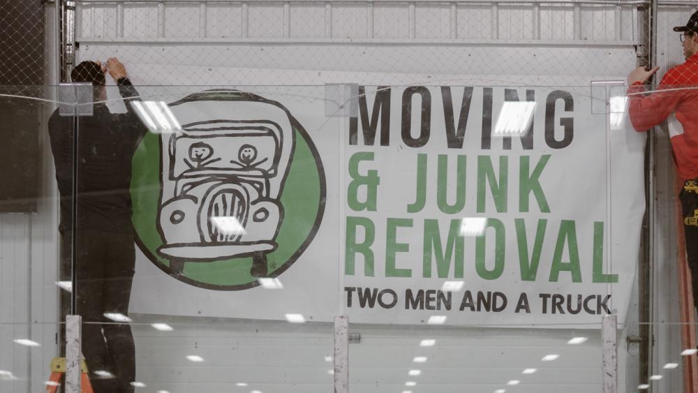 TWO MEN AND A TRUCK SPONSORSHIP BANNER GOING UP