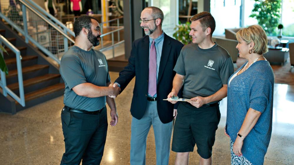 Handshake between movers and business professional