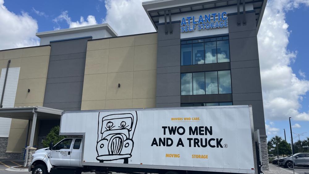 TWO MEN AND A TRUCK moving truck outside Atlantic Self Storage in Jacksonville