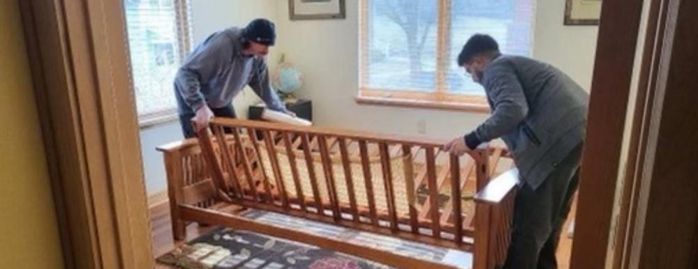 Two Men WITHOUT a Truck team helps a Madison senior resident move furniture.