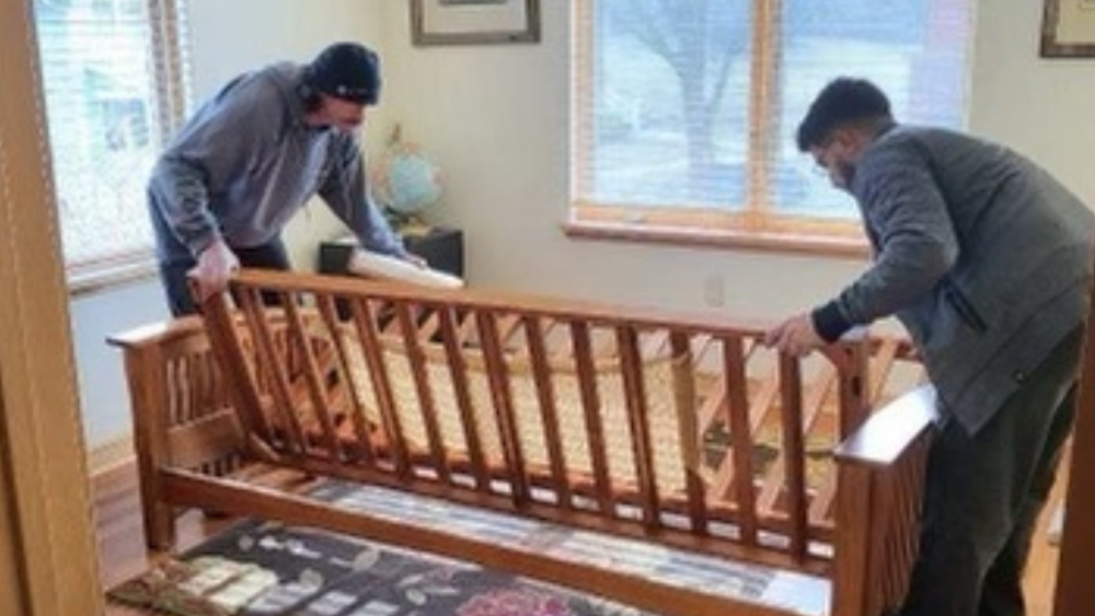 Two Men WITHOUT a Truck team helps a Madison senior resident move furniture.