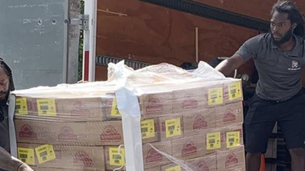 Movers unloading pallets of food