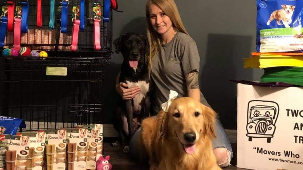Dogs with chew toys and other donations for Movers for Mutts