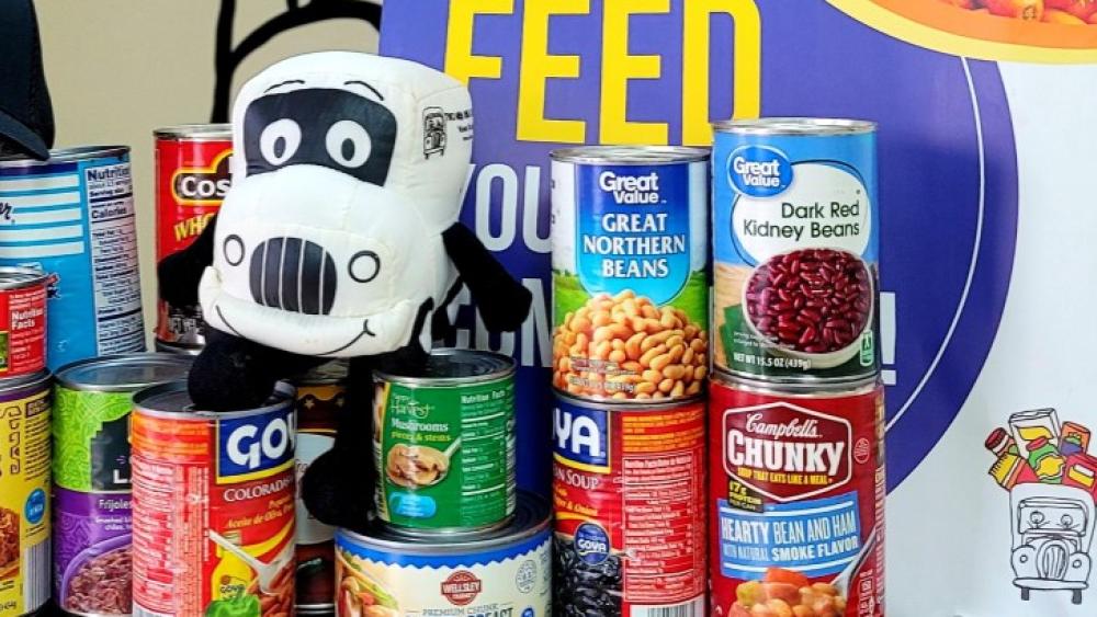 Movers for Meals - Truckie and cans for donation