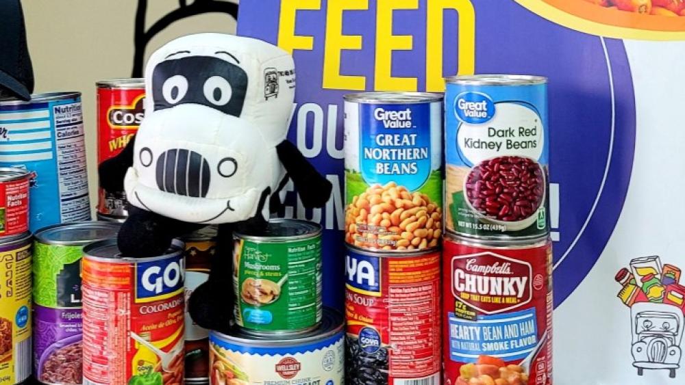 Movers for Meals - Truckie and cans for donation