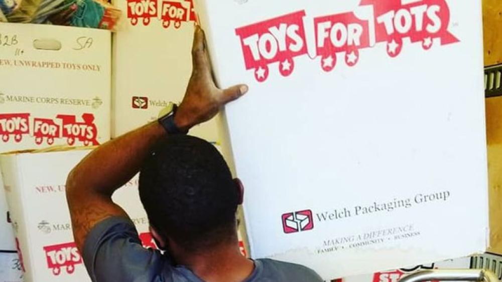 a mover loading a toys for trucks box into a truck