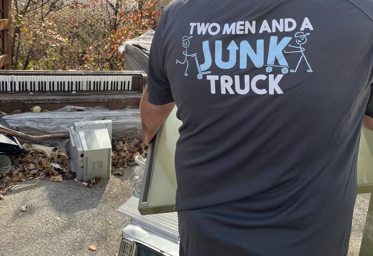 two men and junk truck piano gen