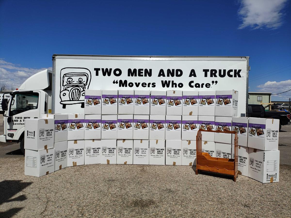 rows of donations in boxes in front of a moving truck