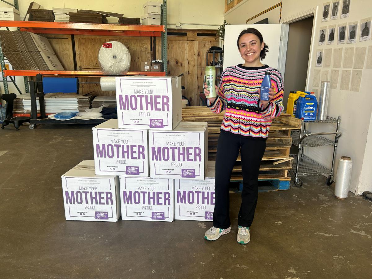 employee standing in front of collection boxes