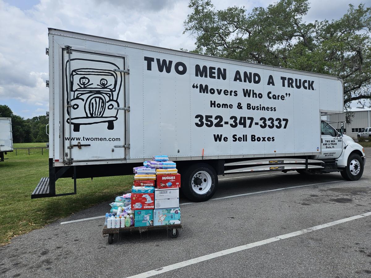 baby supplies on a four-wheel dolly in front of the moving truck