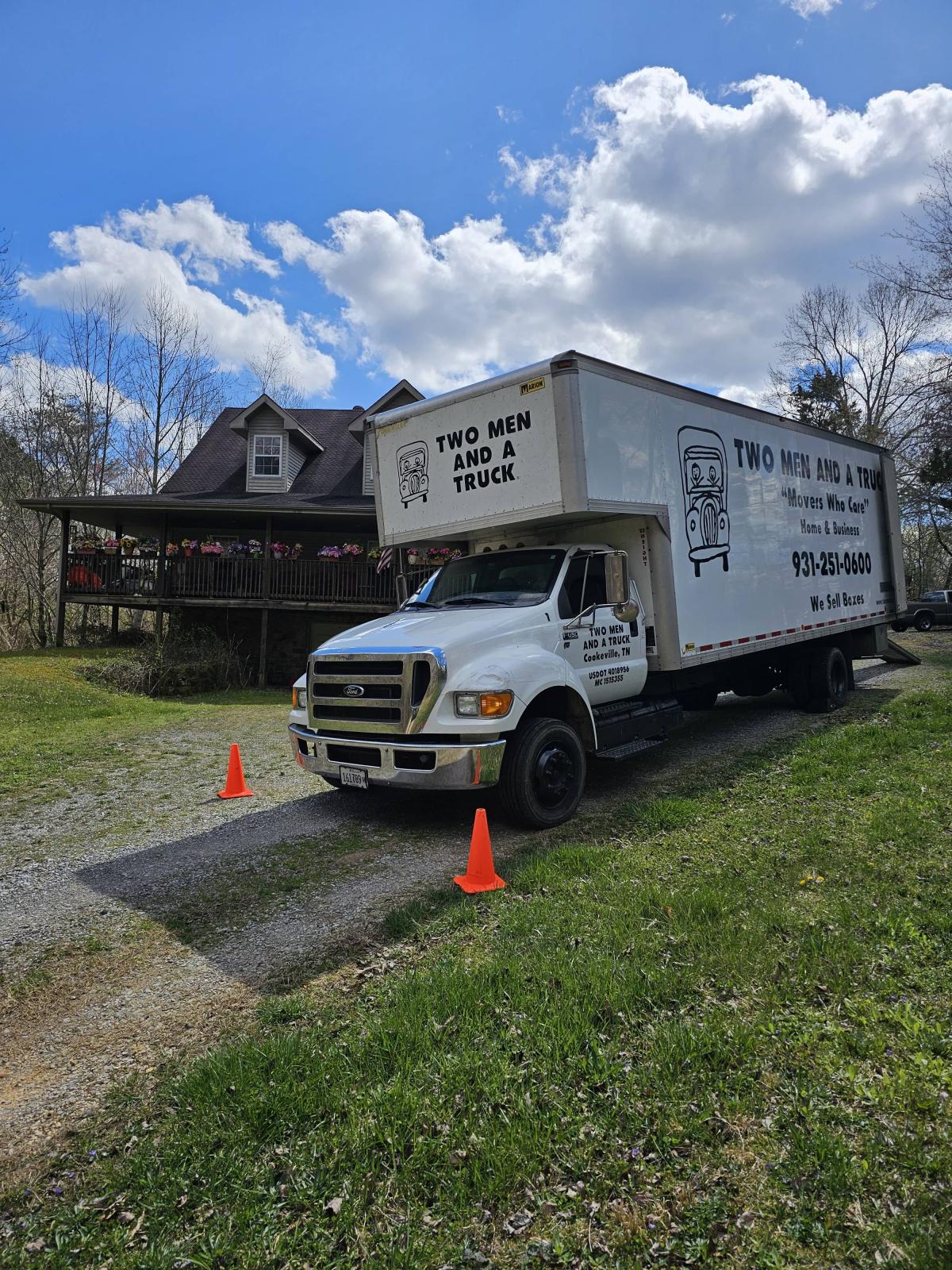 two men and a truck image of truck and house in cookeville tn
