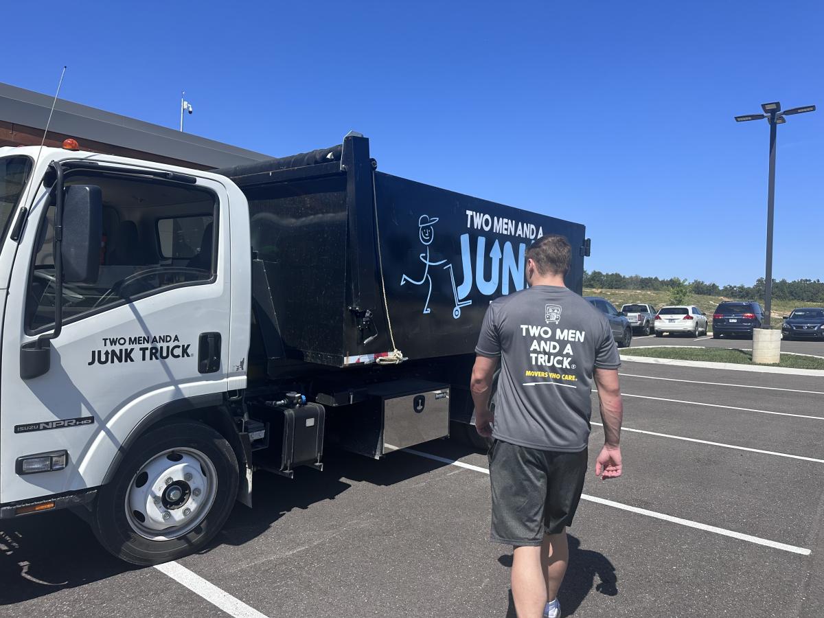 two men and a junk truck image of junk removal truck in cookeville tn