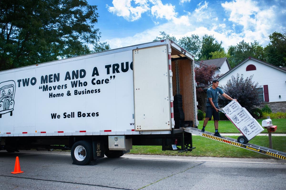 TWO MEN AND A TRUCK mover talking with customers 