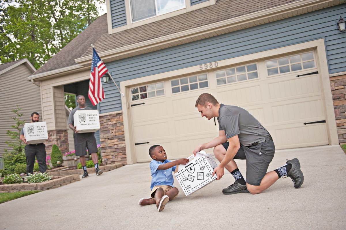 Movers talking with kid during a move