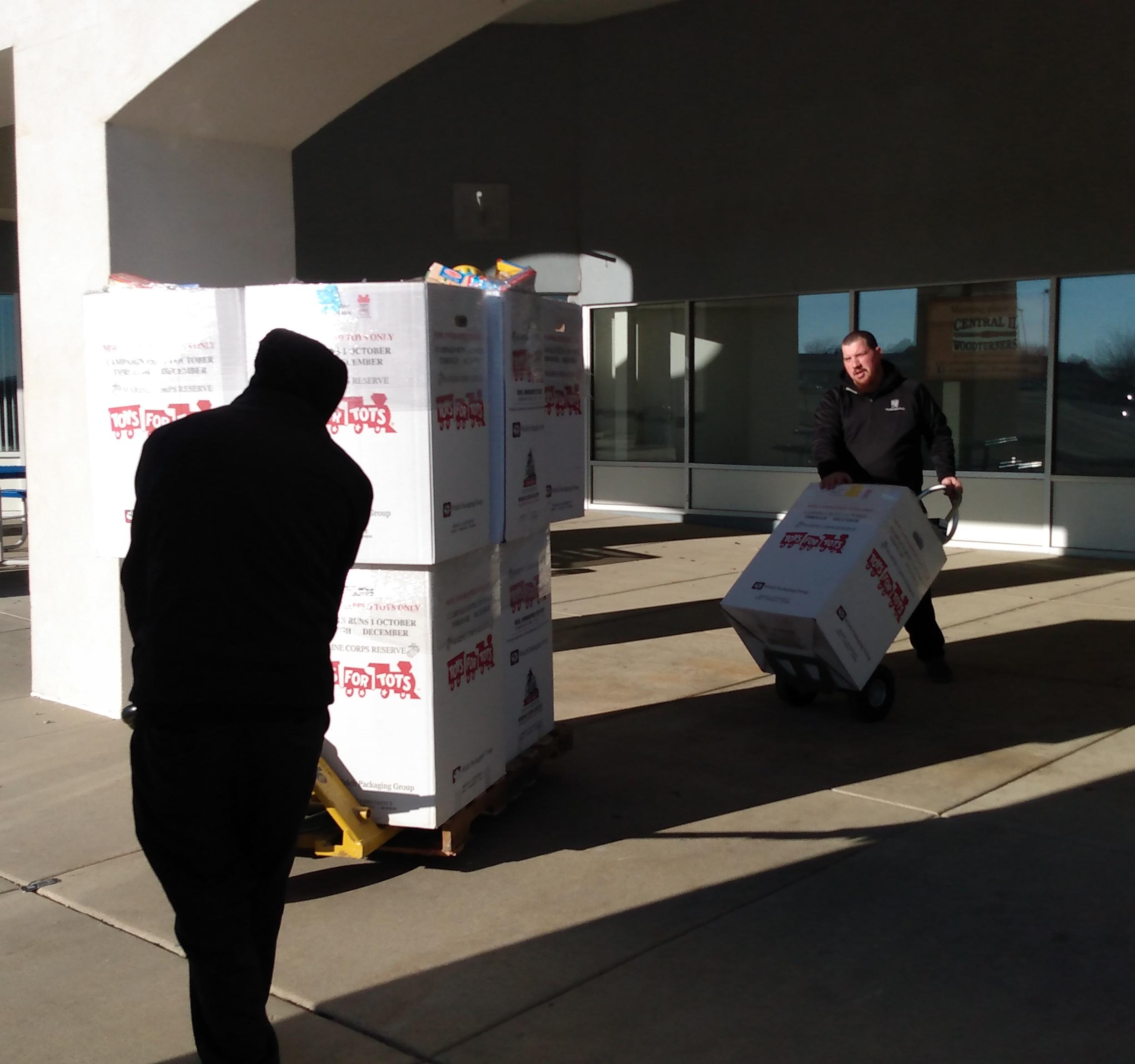 Movers moving Toys For Tots boxes