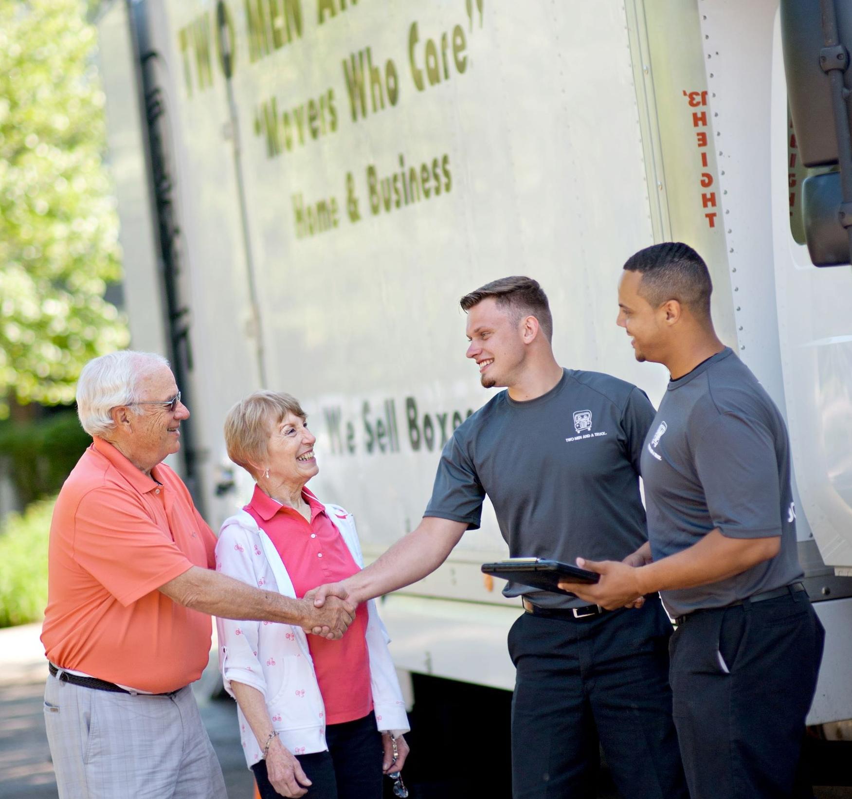 Two Men and A Truck shaking hands with senior customers