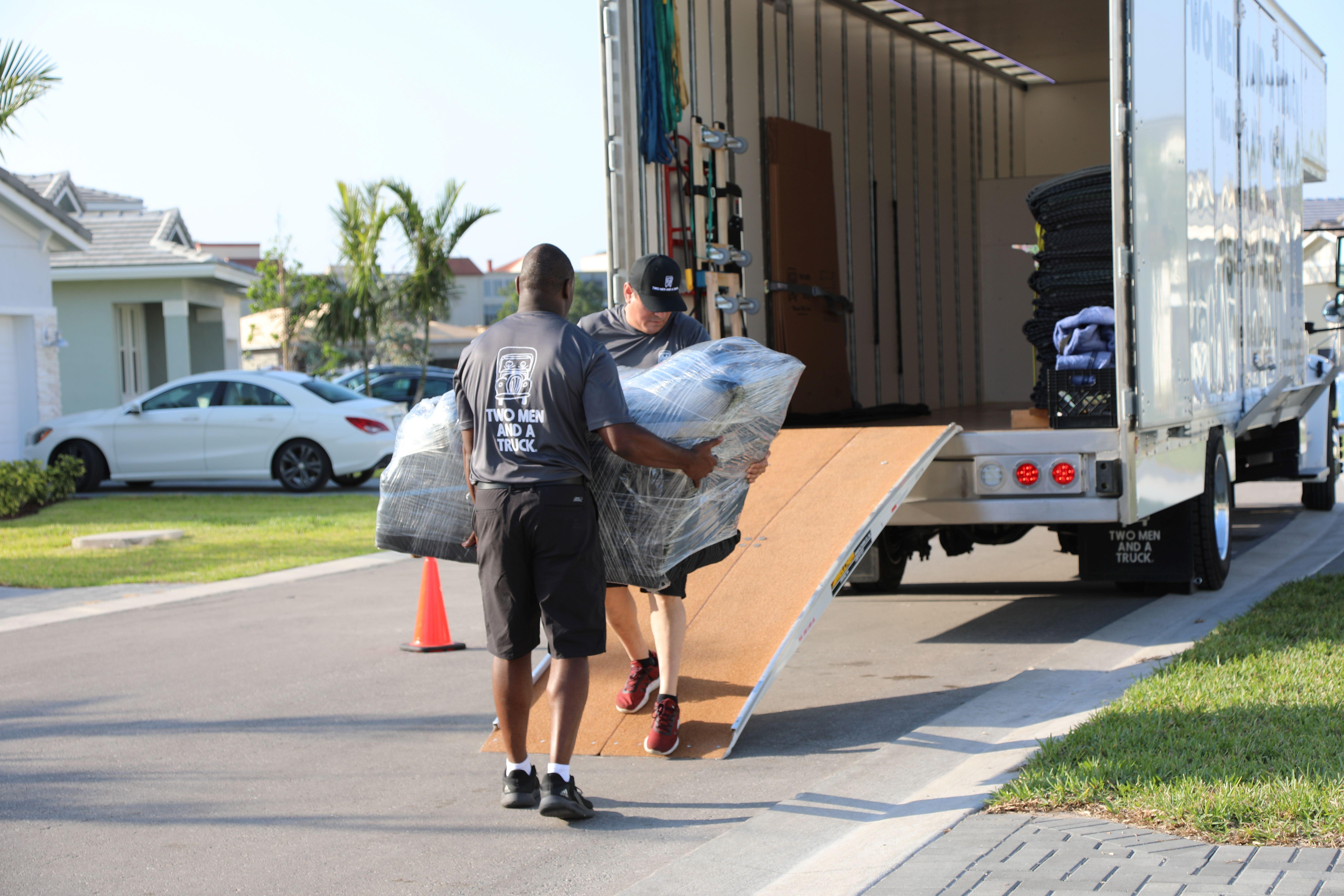 Movers moving furniture into the truck