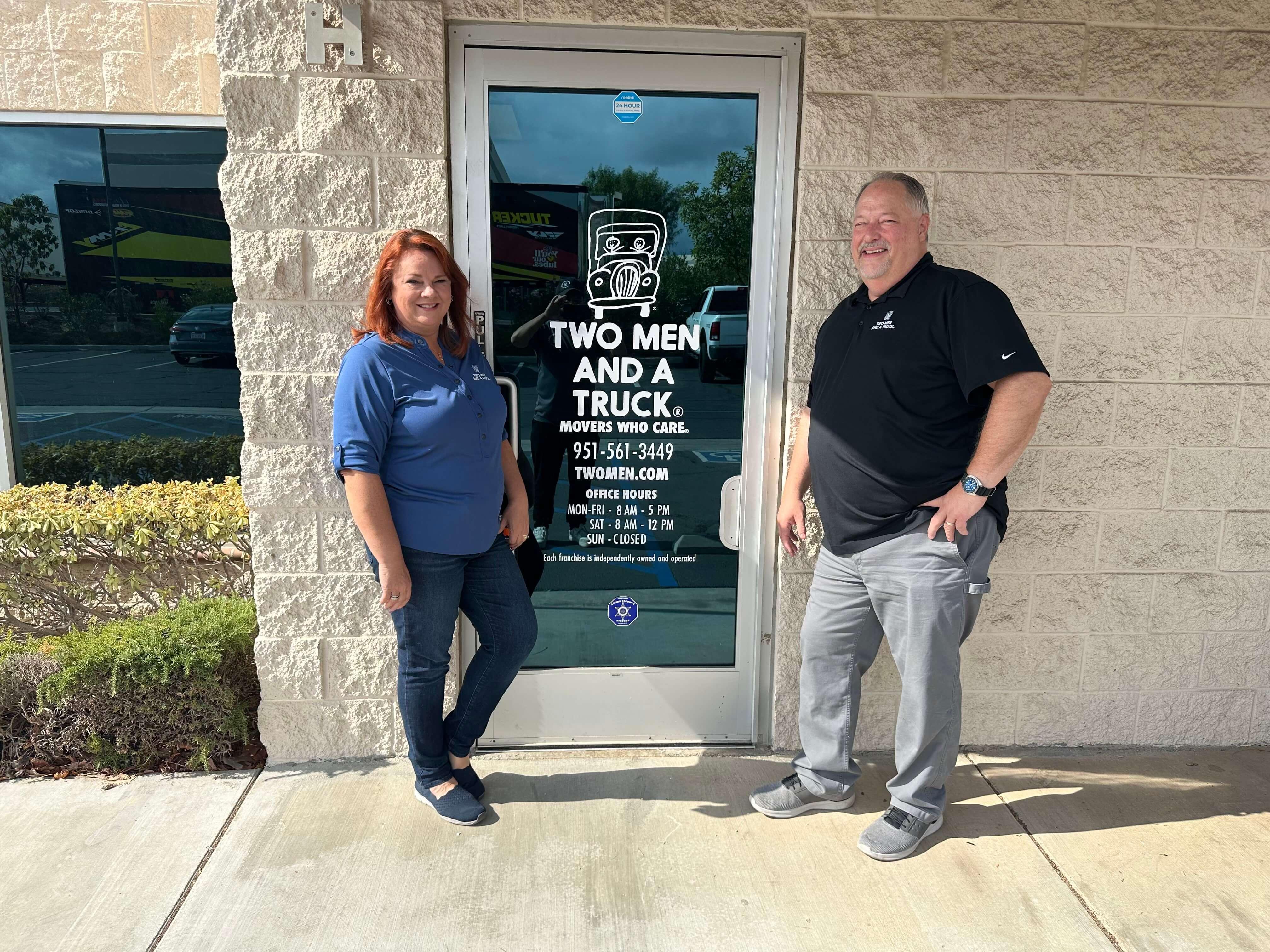 Tim &amp; Natali South standing in front of TWO MEN AND A TRUCK Franchise Door