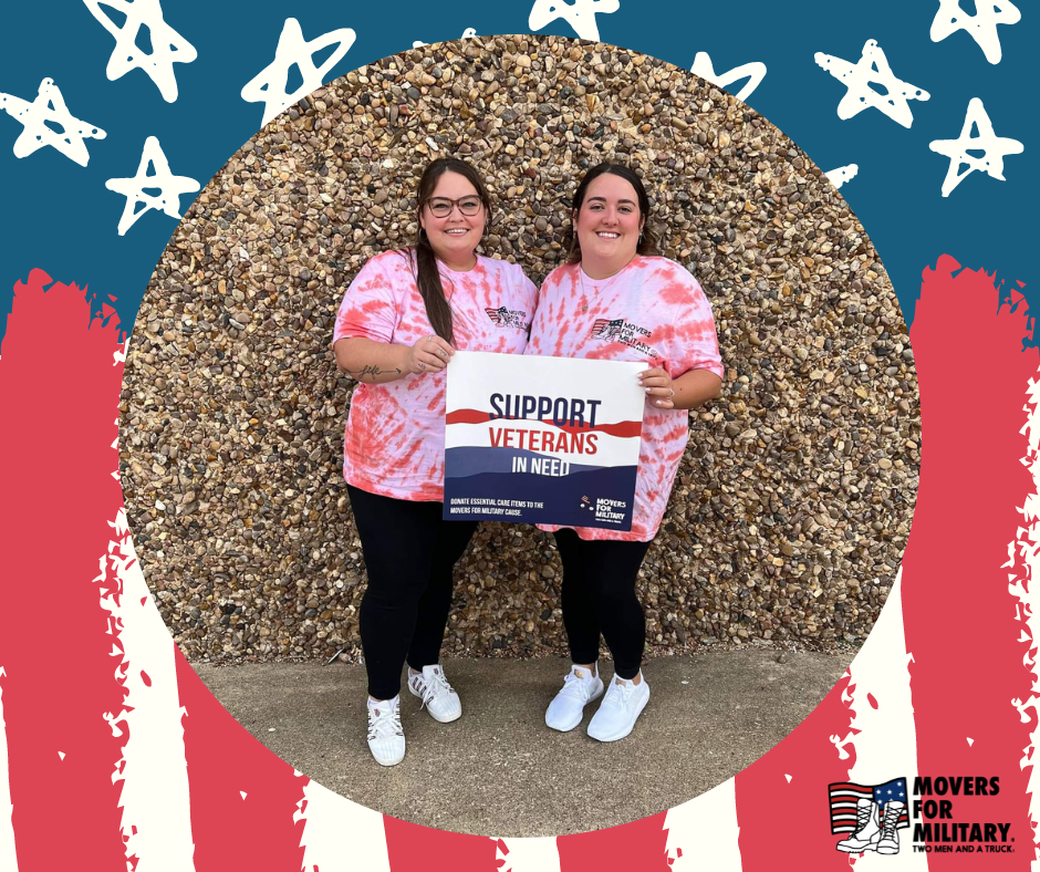 amanda and kayla standing in front of rock wall holding movers for military poster