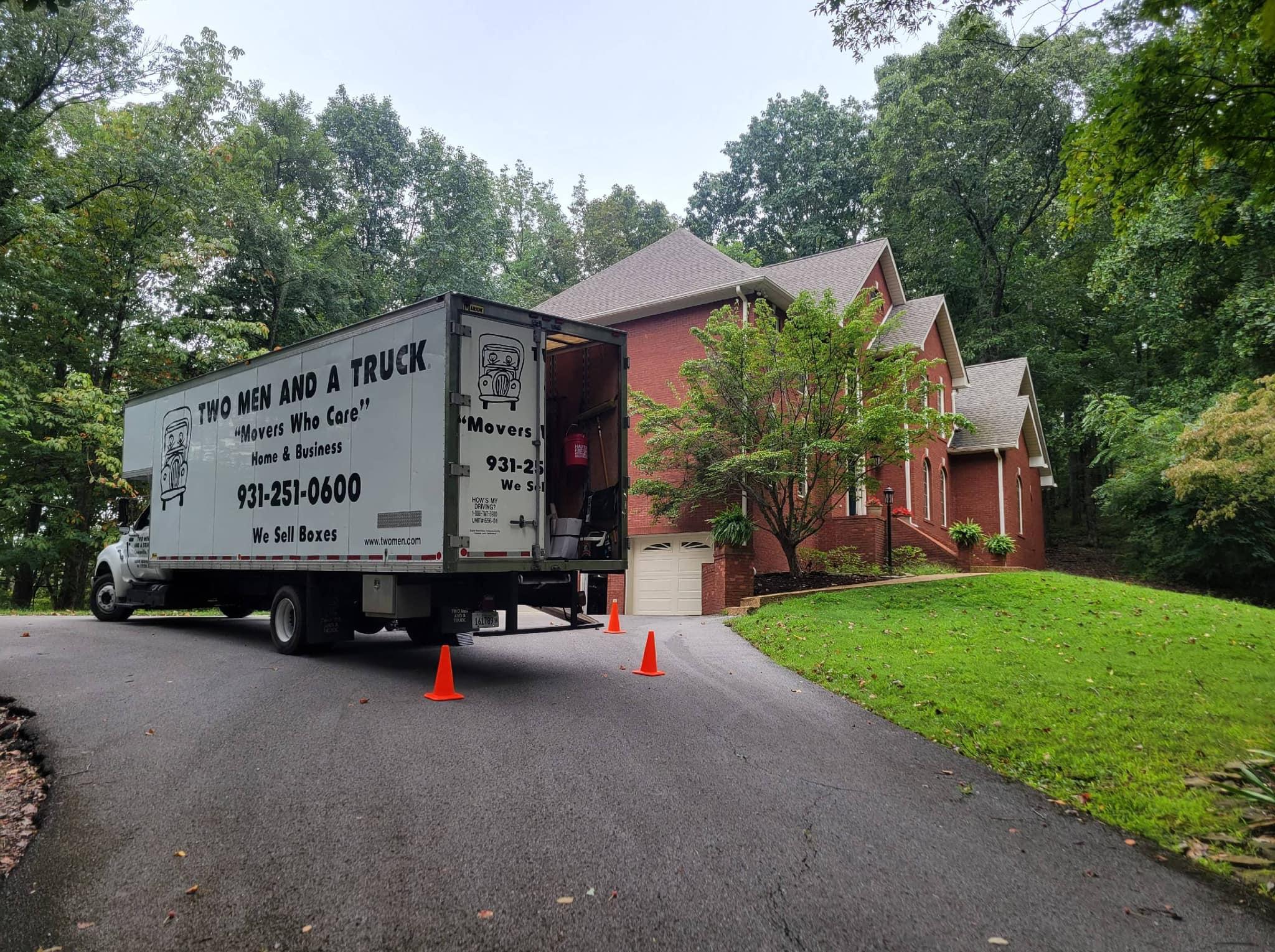 Moving truck parked in front of a house